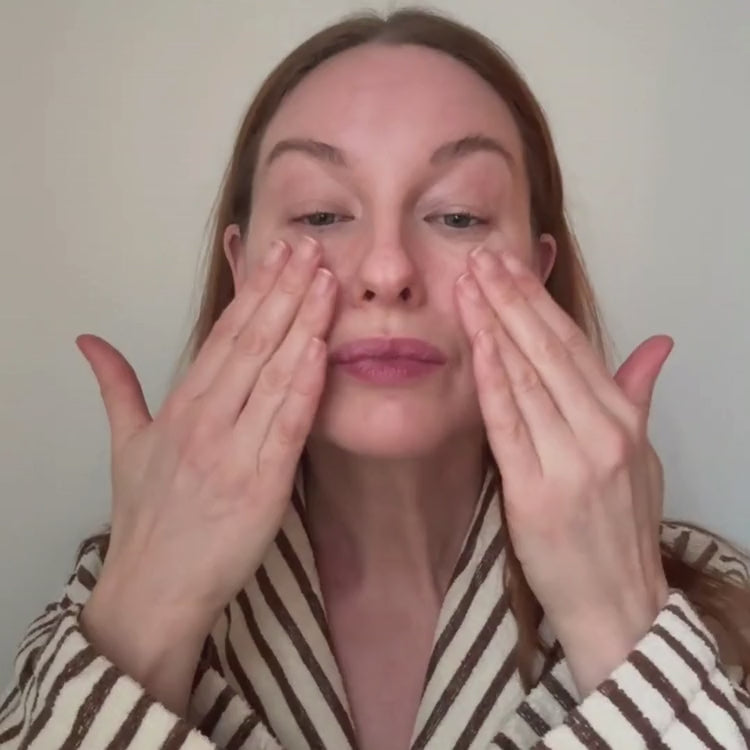 Woman pressing Abloom skincare into her face with both hands